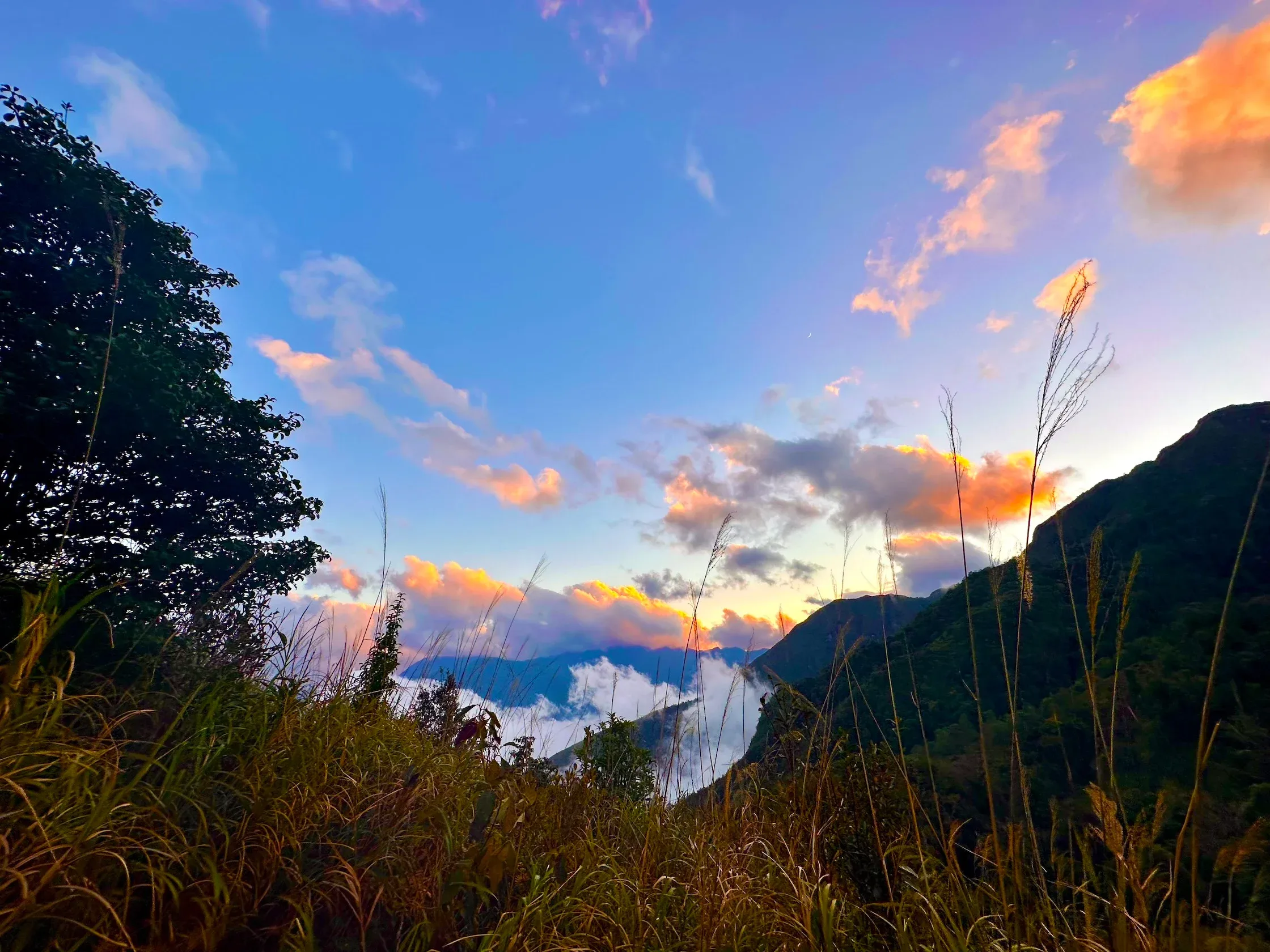 Đoàn trekking trên sườn núi trong ánh bình minh